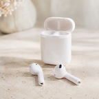 White i7s-style wireless earbuds with charging case on a neutral desk